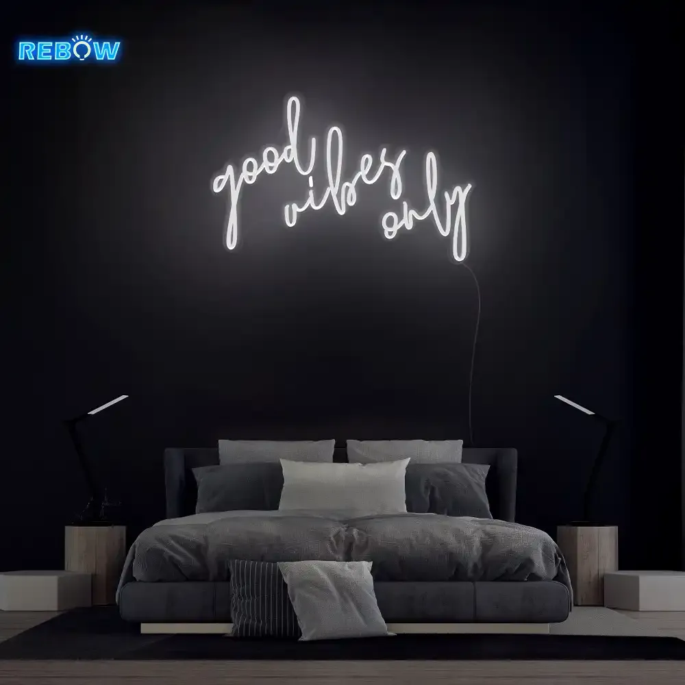 White LED neon sign glowing steadily above a bed