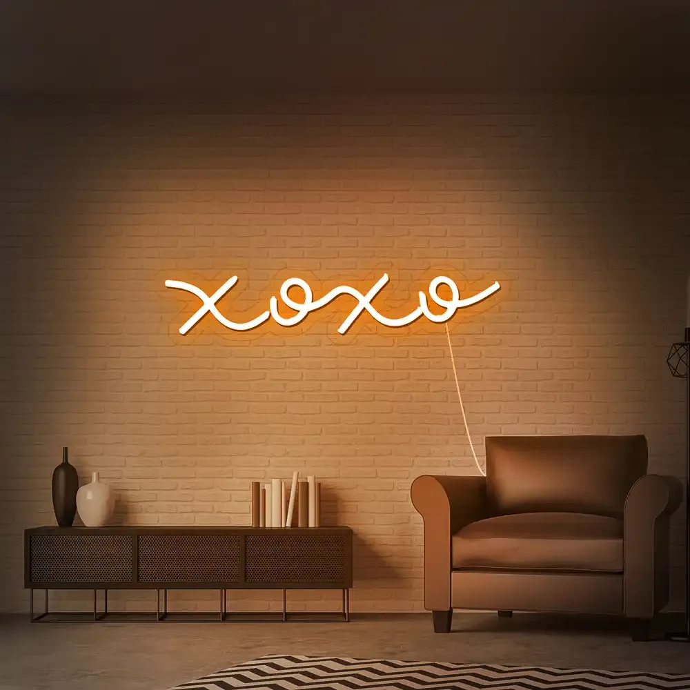 Orange LED neon sign reading XOXO in a living room